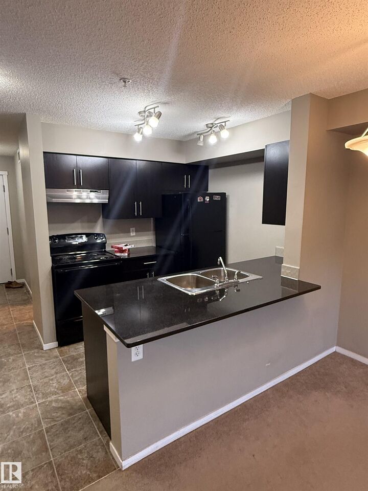 Property Photo: 3207 James Mowatt Trail SW 104 AB T6W 3L6