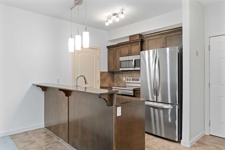 Property Photo: 141 Mountain Street 208 AB T4C 1Z5