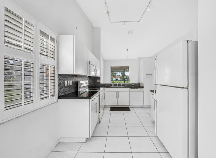 Property Photo:  7857 Whispering Palms Drive 201  FL 33437 